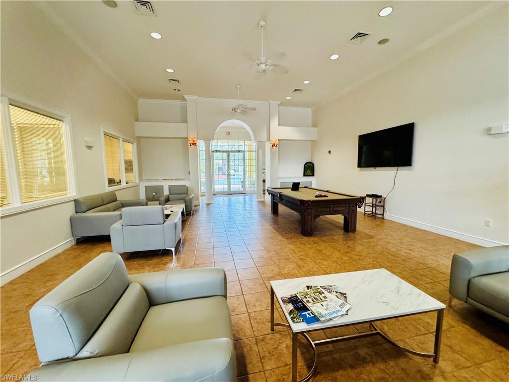 8244 Key Royal Circle, Unit 633 Naples, FL 34119 - Photo 22 of 28 a living room with furniture and a flat screen tv