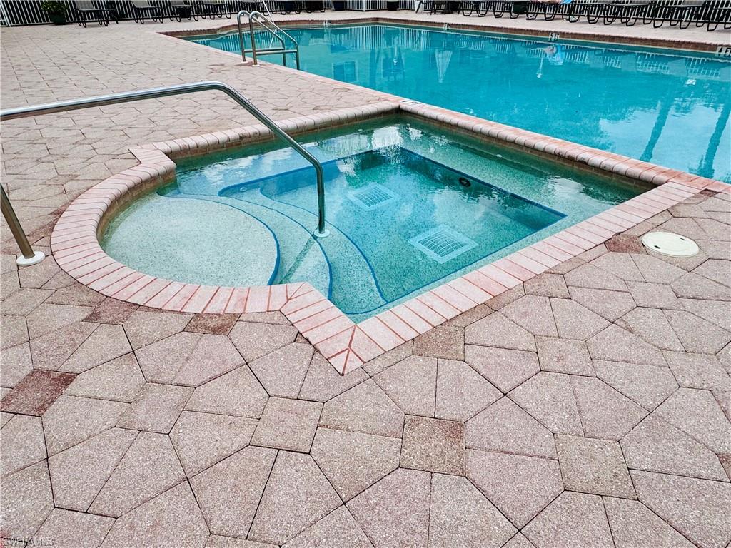 8244 Key Royal Circle, Unit 633 Naples, FL 34119 - Photo 25 of 28 a view of a swimming pool and in the outdoor space