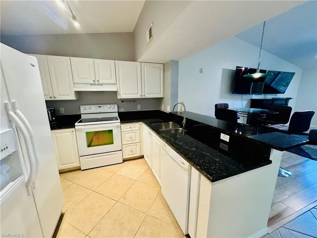 a kitchen with a sink a stove and refrigerator