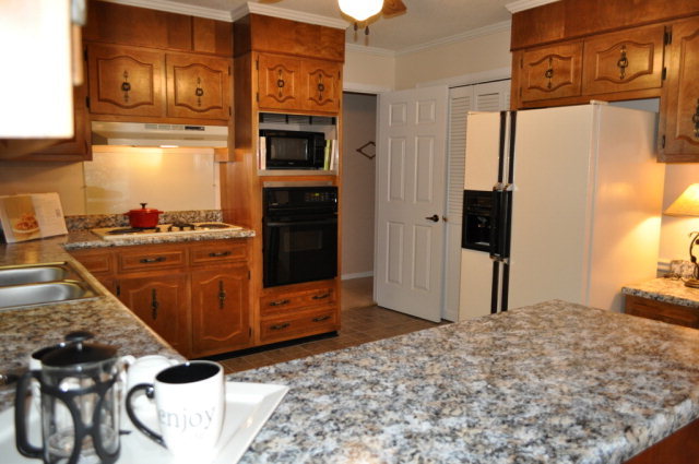 5237 Zebulon Road Macon, GA 31210 - Photo 12 of 33 a kitchen with stainless steel appliances kitchen island granite countertop a refrigerator and a stove