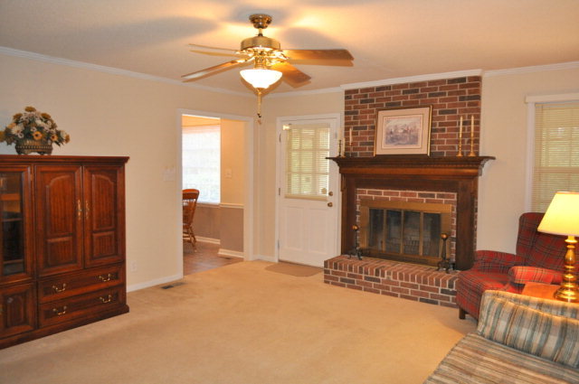 5237 Zebulon Road Macon, GA 31210 - Photo 13 of 33 a living room with furniture and a fireplace