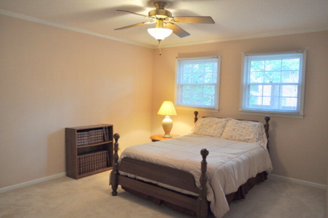 5237 Zebulon Road Macon, GA 31210 - Photo 16 of 33 a bedroom with a bed and a chandelier