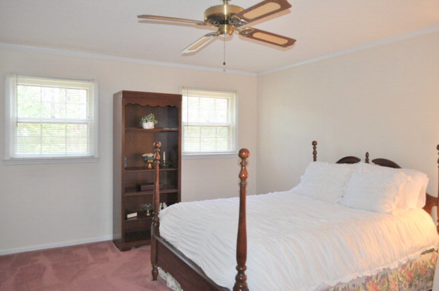 5237 Zebulon Road Macon, GA 31210 - Photo 23 of 33 a bedroom with a bed and a chandelier
