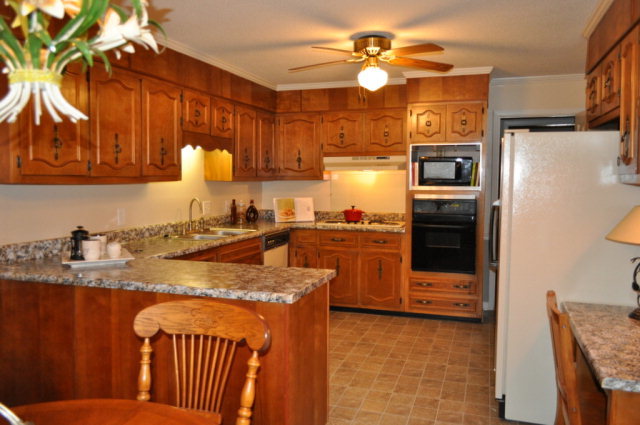 5237 Zebulon Road Macon, GA 31210 - Photo 27 of 33 a kitchen with stainless steel appliances granite countertop a sink a stove a refrigerator a washer and dryer