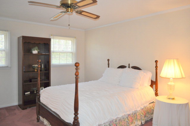5237 Zebulon Road Macon, GA 31210 - Photo 31 of 33 a bedroom with a bed and a chandelier