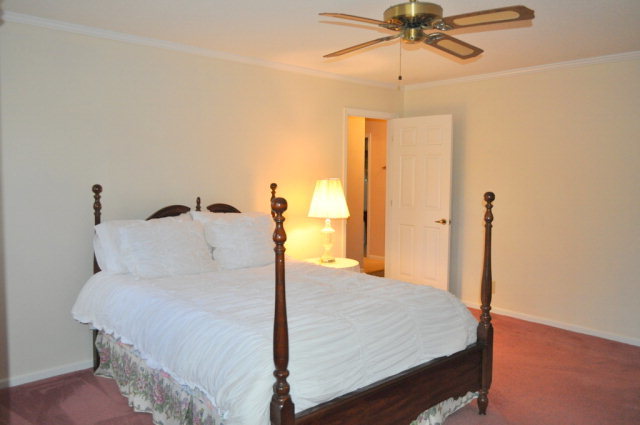 5237 Zebulon Road Macon, GA 31210 - Photo 32 of 33 a bed room with a bed and a chandelier