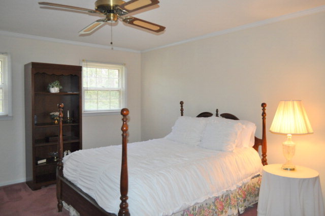 5237 Zebulon Road Macon, GA 31210 - Photo 10 of 33 a bedroom with a bed and a chandelier