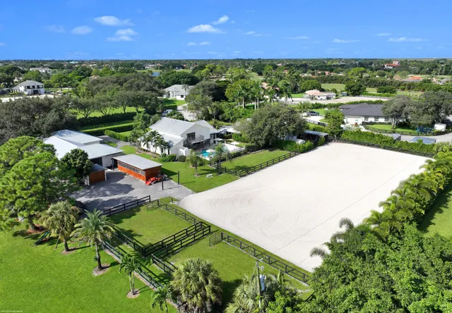 an aerial view of a house with a garden and swimming pool