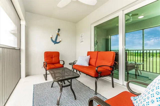 an outdoor cafe with a table and chairs under an umbrella
