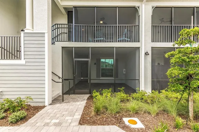 a dining room with lots of wooden furniture and a chandelier