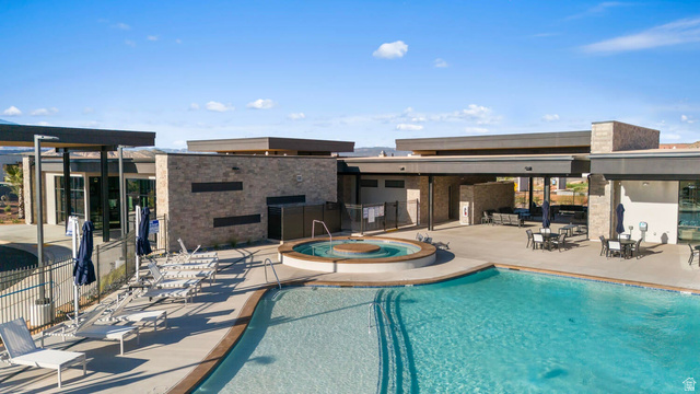2133 Wolverine Way, Unit 2440 Washington, UT 84780 - Photo 26 of 39 Resort-style pool area featuring an expansive swimming pool and an integrated spa