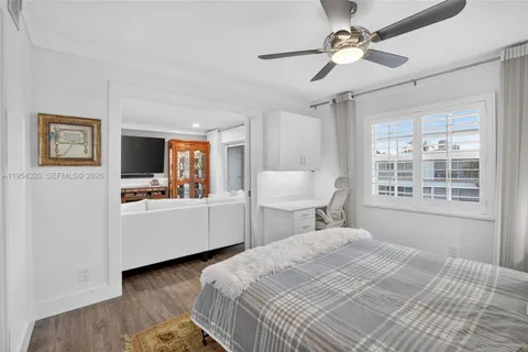 a living room with furniture kitchen view and a chandelier