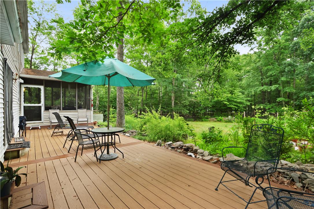 209 Remington Road East Stroudsburg, PA 18301 - Photo 5 of 41 An inviting deck offers a serene, wooded backdrop for relaxed outdoor living.