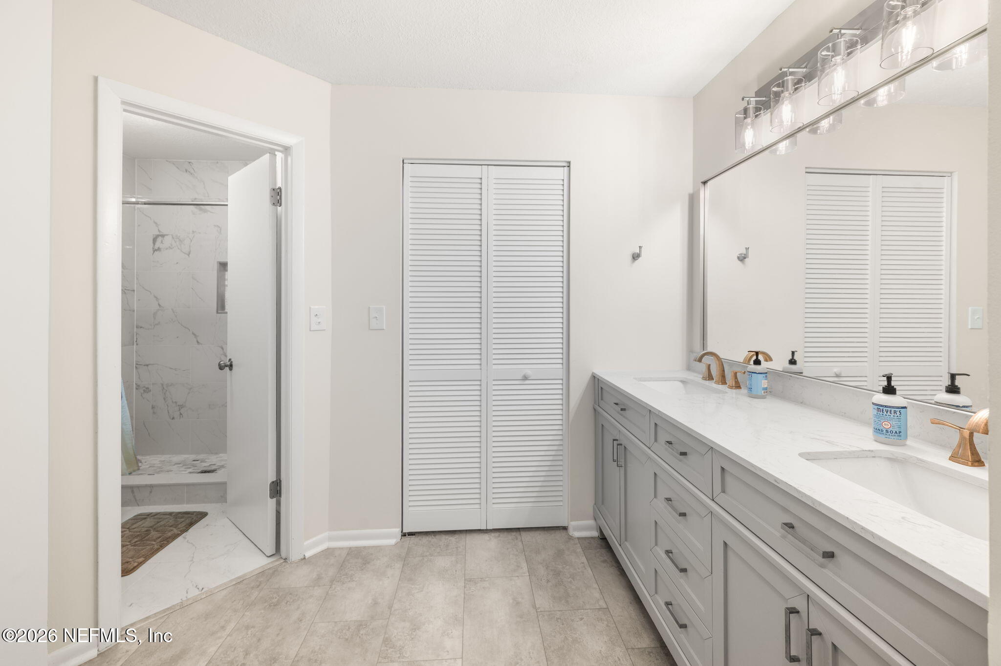 507 Gentian Road St. Augustine, FL 32086 - Photo 28 of 82 a spacious bathroom with a double vanity sink mirror and shower