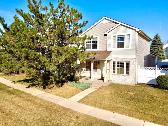 a view of a white house with a yard
