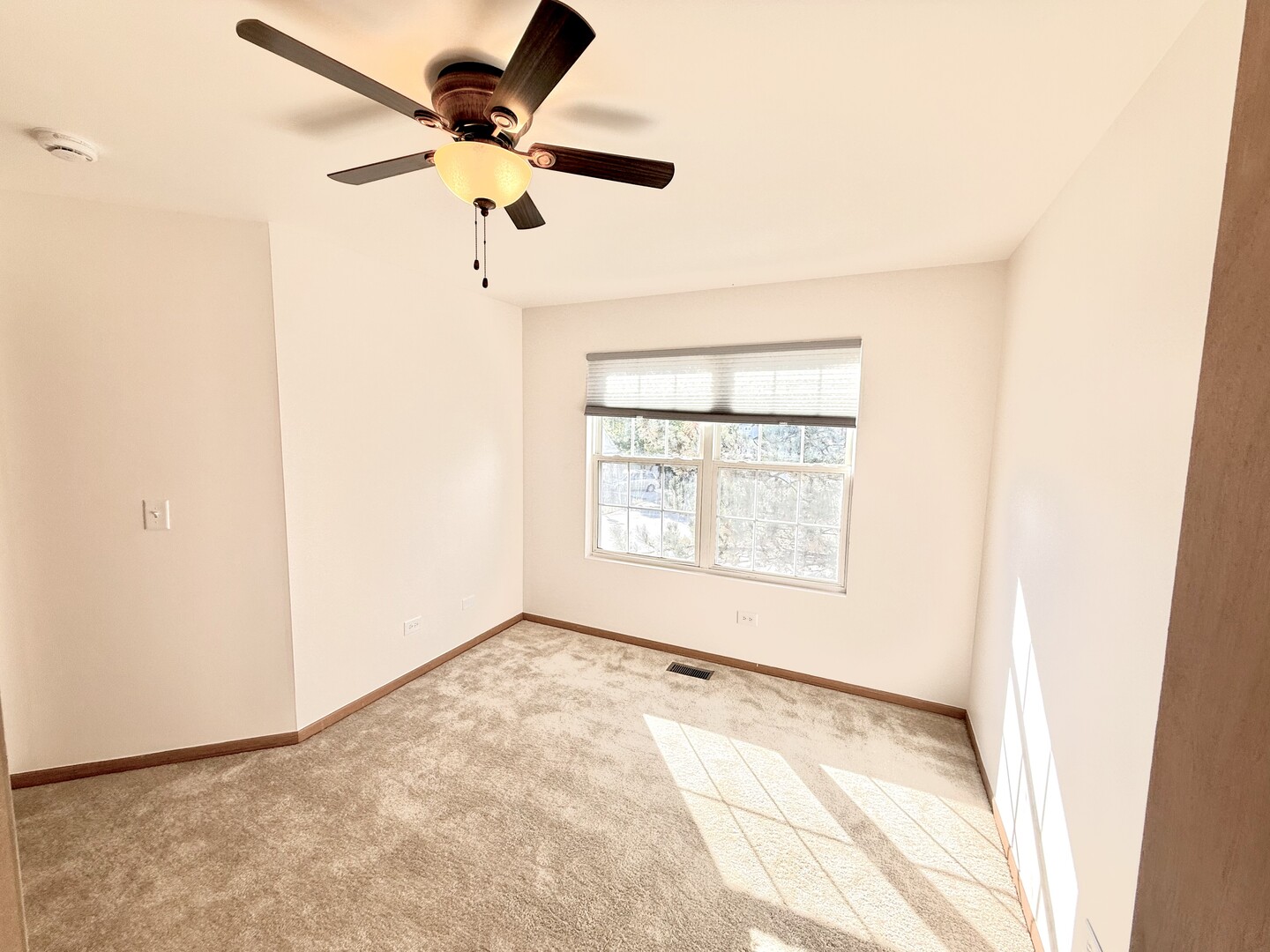 138 Mountain Laurel Court Romeoville, IL 60446 - Photo 16 of 26 an empty room with a window and a ceiling fan