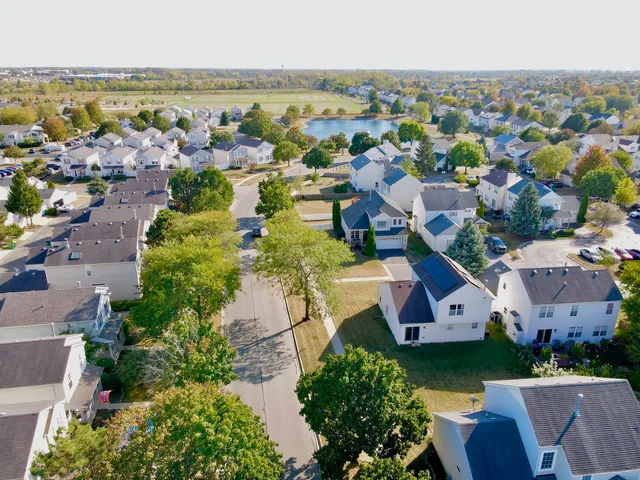 an aerial view of house with yard and ocean view