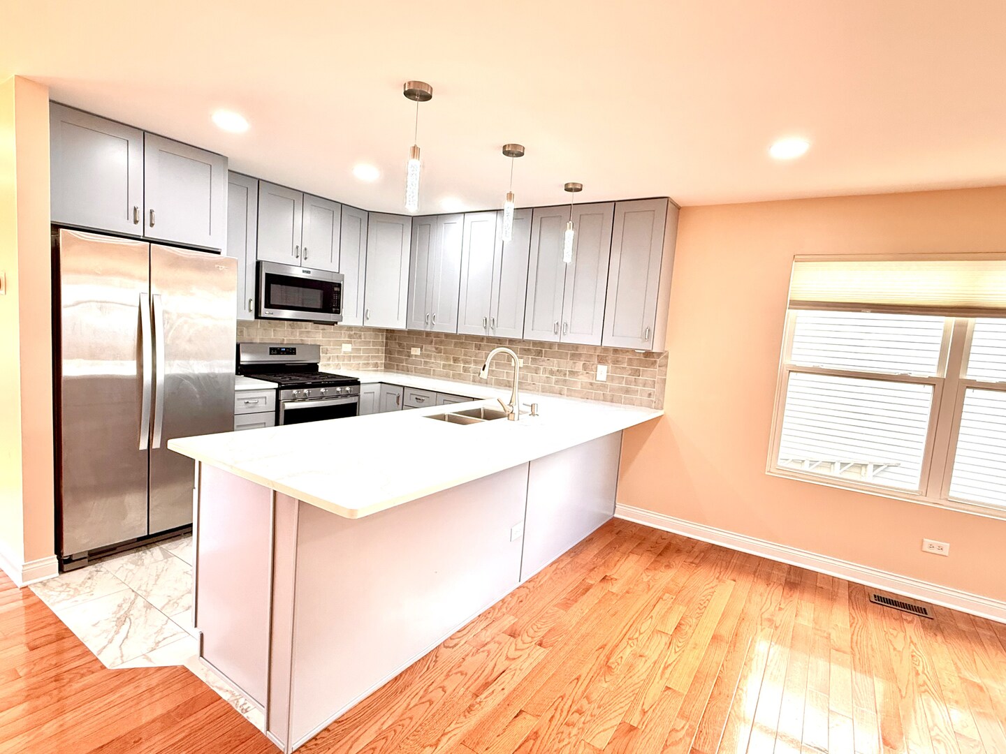 138 Mountain Laurel Court Romeoville, IL 60446 - Photo 4 of 26 a kitchen with kitchen island a counter top space a sink stainless steel appliances and cabinets