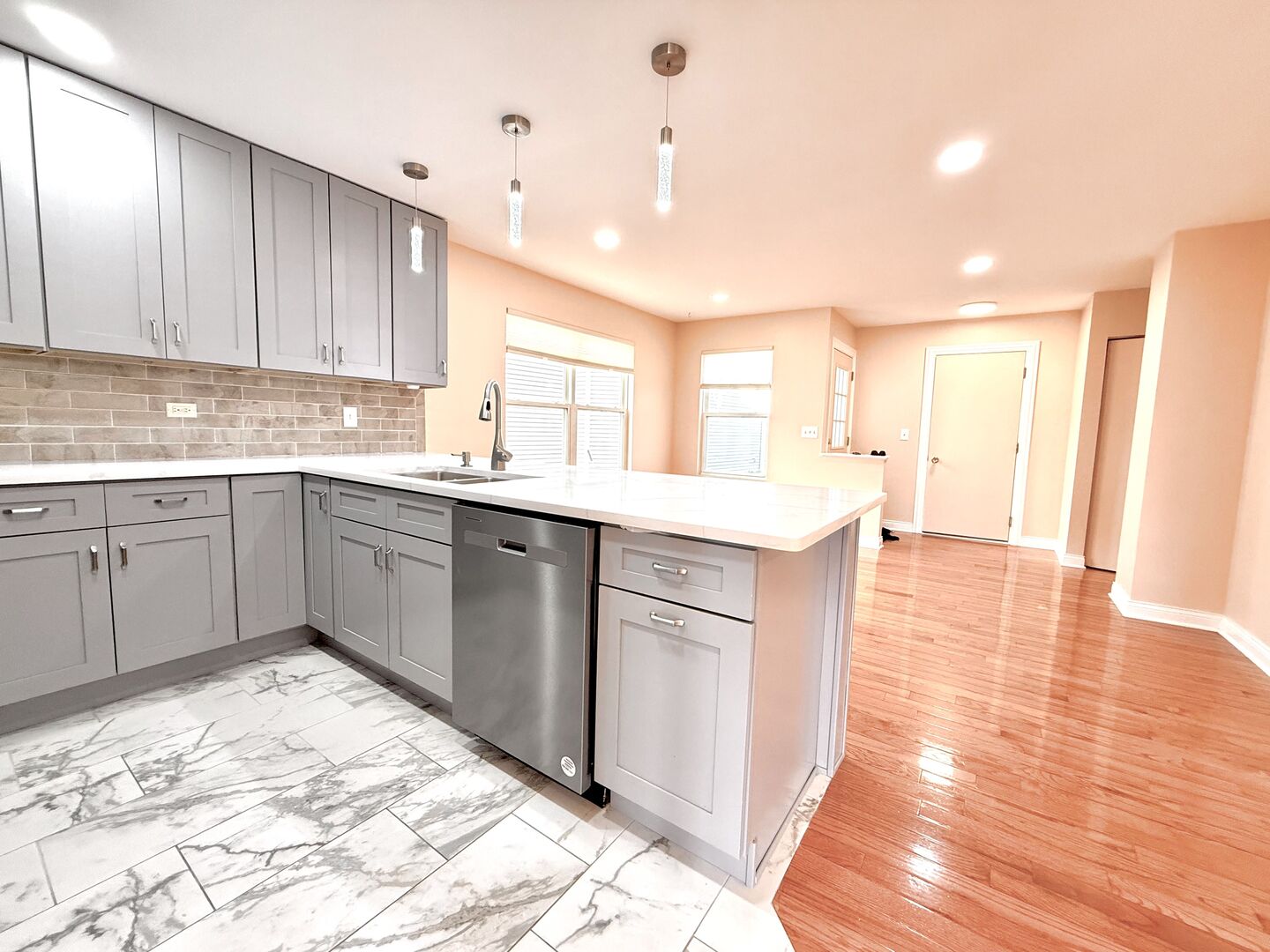 138 Mountain Laurel Court Romeoville, IL 60446 - Photo 5 of 26 a kitchen with a sink cabinets and wooden floor