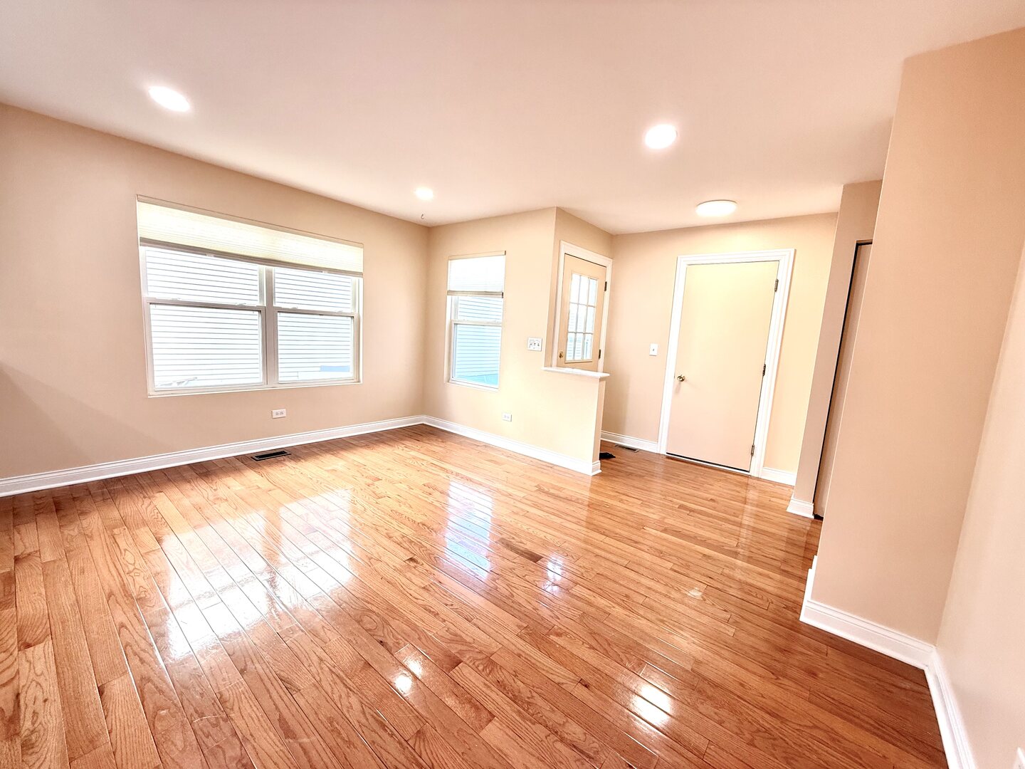 138 Mountain Laurel Court Romeoville, IL 60446 - Photo 8 of 26 an empty room with wooden floor and windows