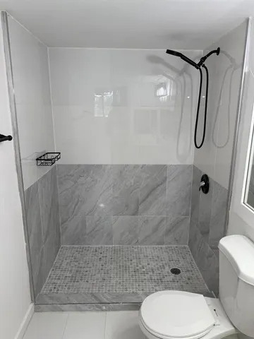 a bathroom with a sink toilet and shower