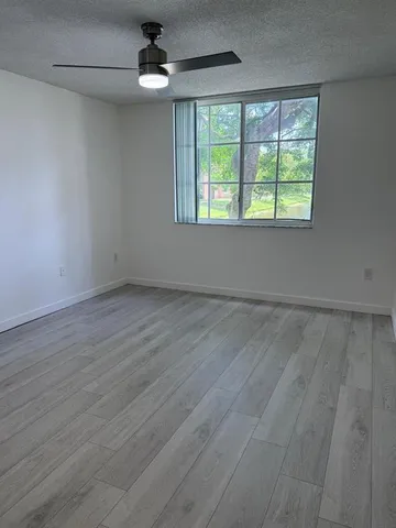 a kitchen with granite countertop a sink and cabinets