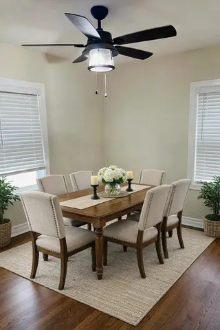 an empty room with wooden floor chandelier fan and windows