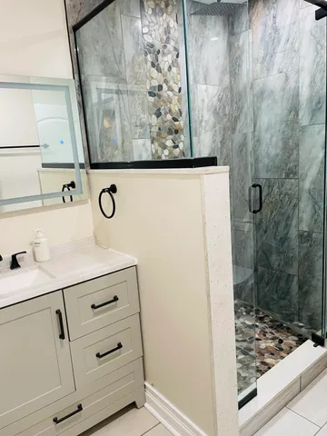 a bathroom with a toilet and a shower