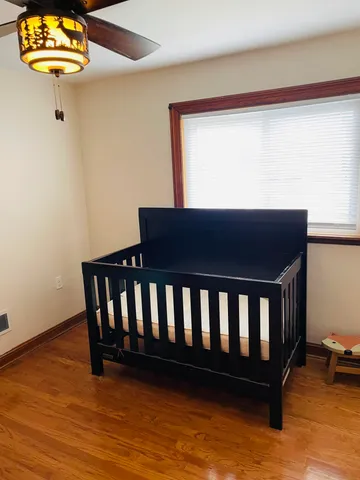 a view of a room with wooden floor and window