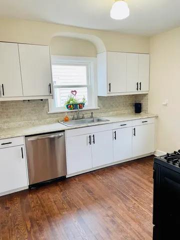 a stove top oven sitting inside of a kitchen