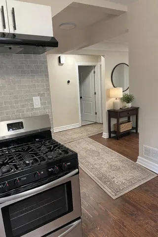 a stove top oven sitting inside of a kitchen