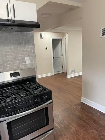 a stove top oven sitting inside of a kitchen