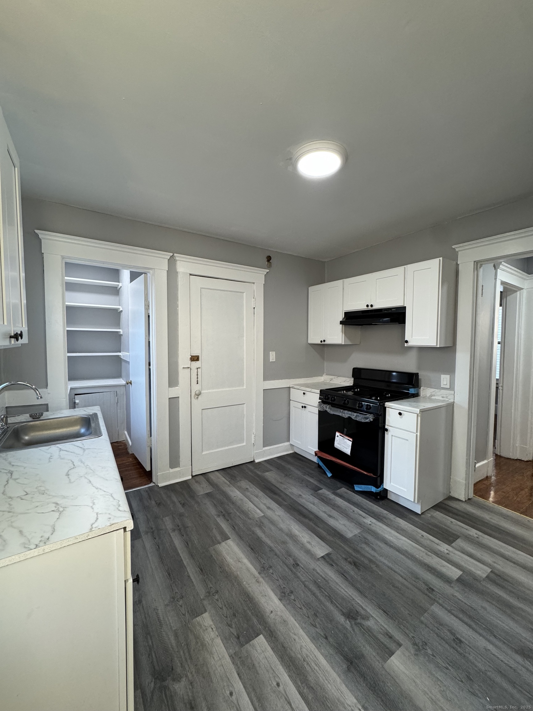 1528 Ella T Grasso Boulevard, Unit 2 New Haven, CT 06511 - Photo 2 of 10 a kitchen with granite countertop a stove and a refrigerator