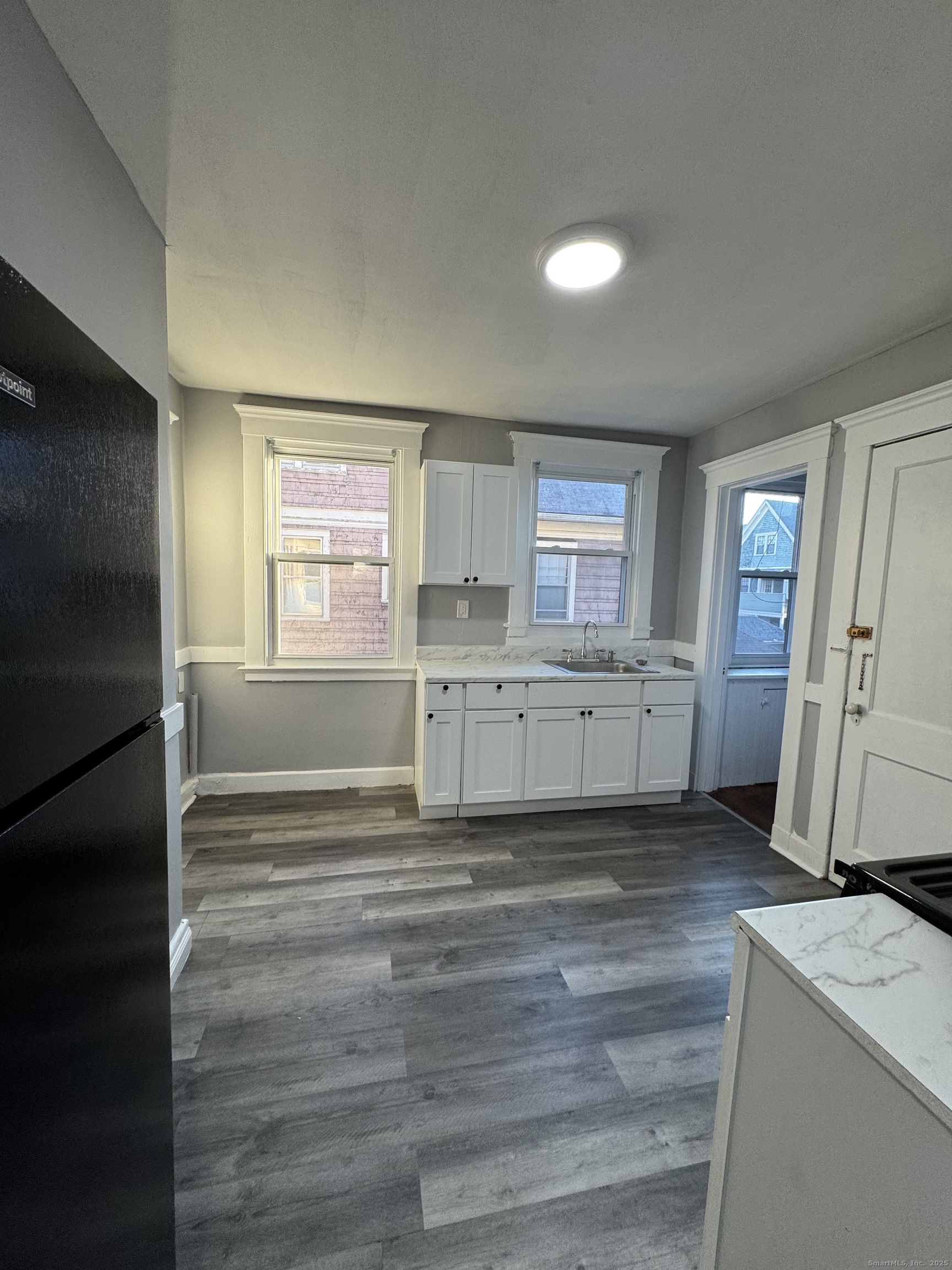 1528 Ella T Grasso Boulevard, Unit 2 New Haven, CT 06511 - Photo 3 of 10 a view of a kitchen with a sink dishwasher cabinets and a wooden floor