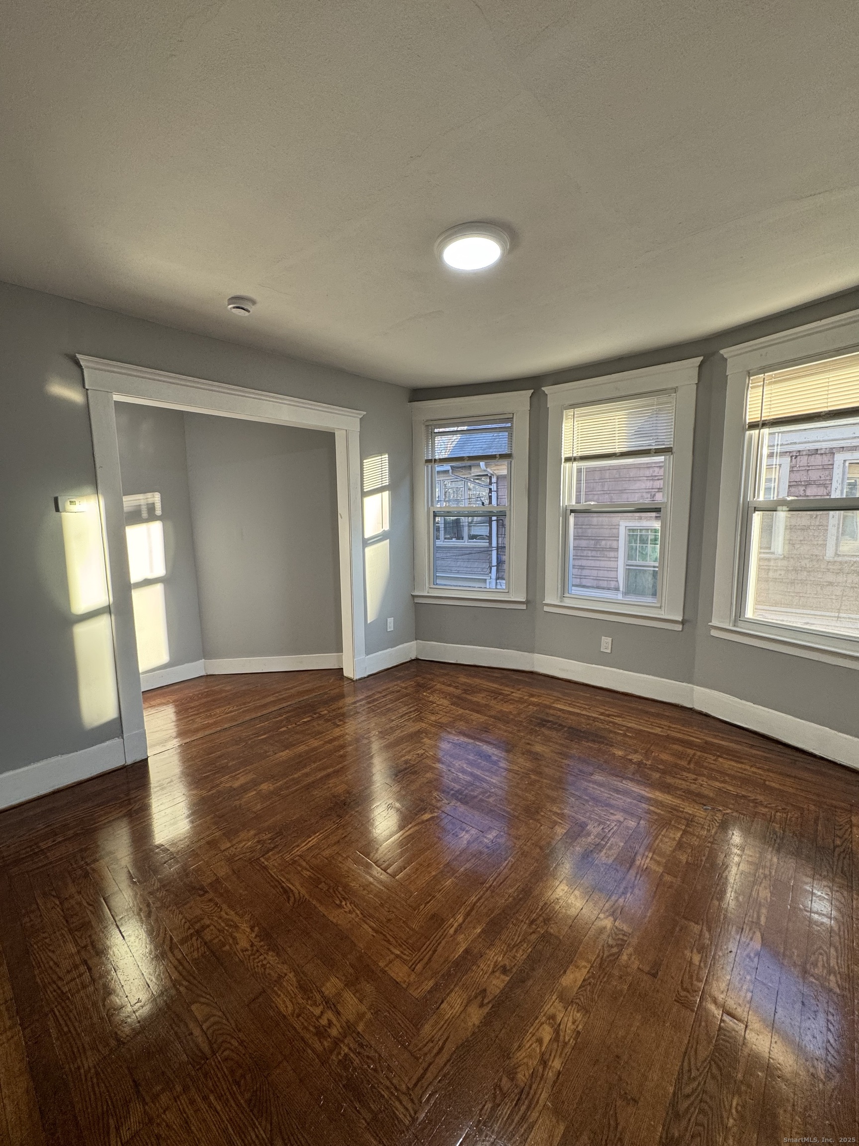 1528 Ella T Grasso Boulevard, Unit 2 New Haven, CT 06511 - Photo 5 of 10 a view of empty room with wooden floor and fan