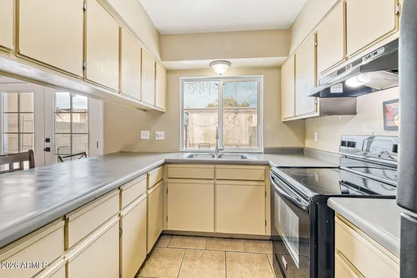 a kitchen that has a sink and a stove in it