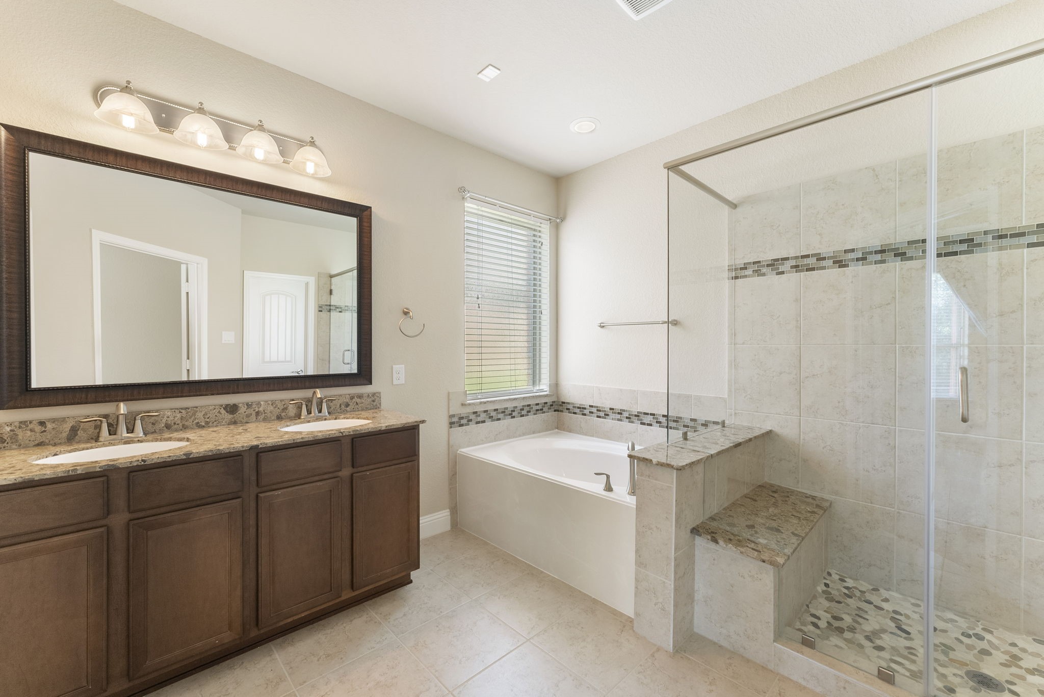 3565 Falcon Way Conroe, TX 77304 - Photo 21 of 50 Primary bathroom featuring dual sinks, soaking tub and separate walk-in shower.