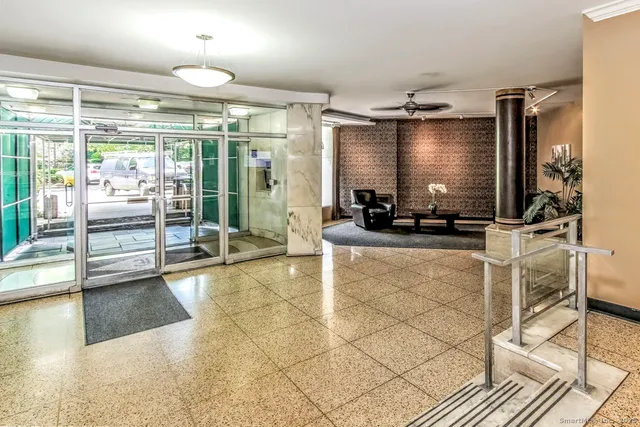 a lobby with furniture and floor to ceiling window