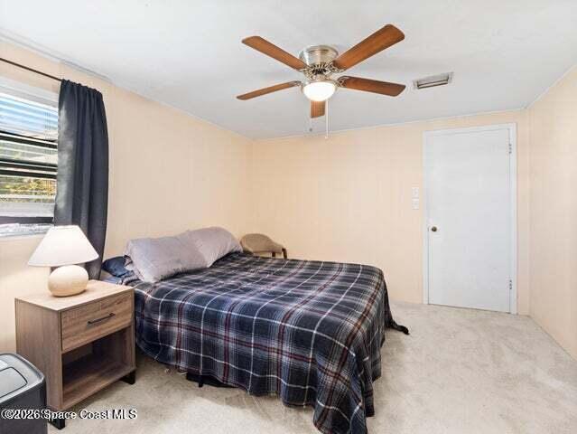 322 3rd Street Merritt Island, FL 32953 - Photo 18 of 37 a bedroom with bed and window