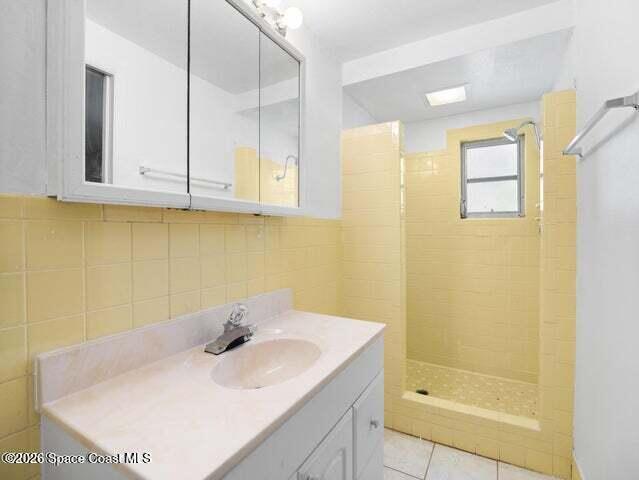 322 3rd Street Merritt Island, FL 32953 - Photo 20 of 37 a bathroom with a sink a shower and a mirror