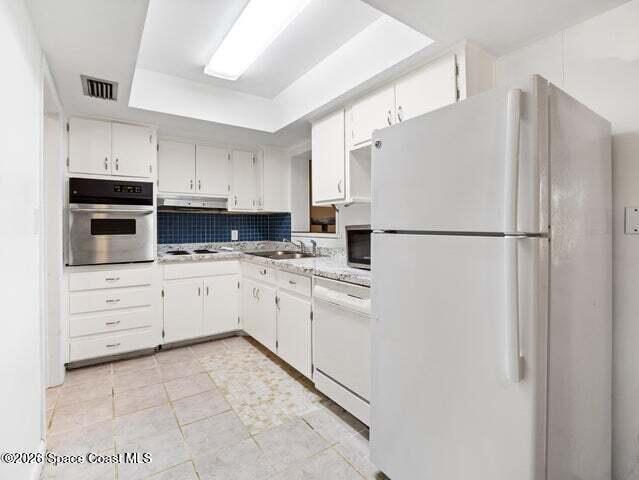 322 3rd Street Merritt Island, FL 32953 - Photo 23 of 37 a kitchen with cabinets stainless steel appliances and counter space