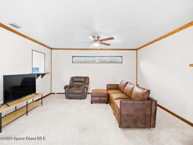 322 3rd Street Merritt Island, FL 32953 - Photo 28 of 37 a living room with furniture and a flat screen tv