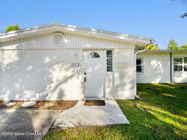 322 3rd Street Merritt Island, FL 32953 - Photo 3 of 37 a front view of a house with a yard