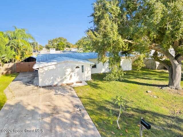 322 3rd Street Merritt Island, FL 32953 - Photo 5 of 37 a view of a house with a yard