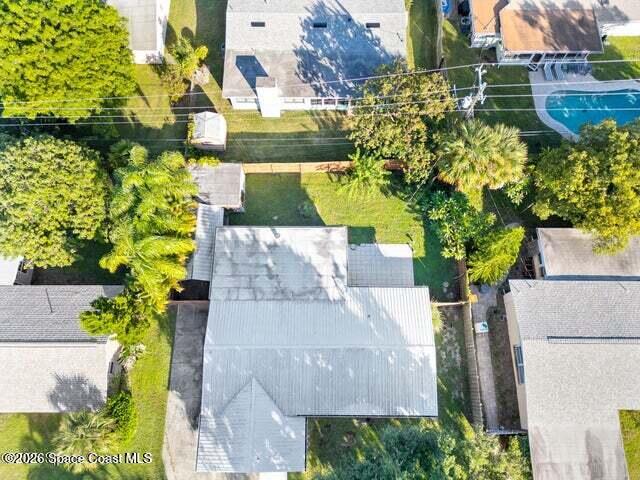322 3rd Street Merritt Island, FL 32953 - Photo 9 of 37 an aerial view of a house with a yard and large trees