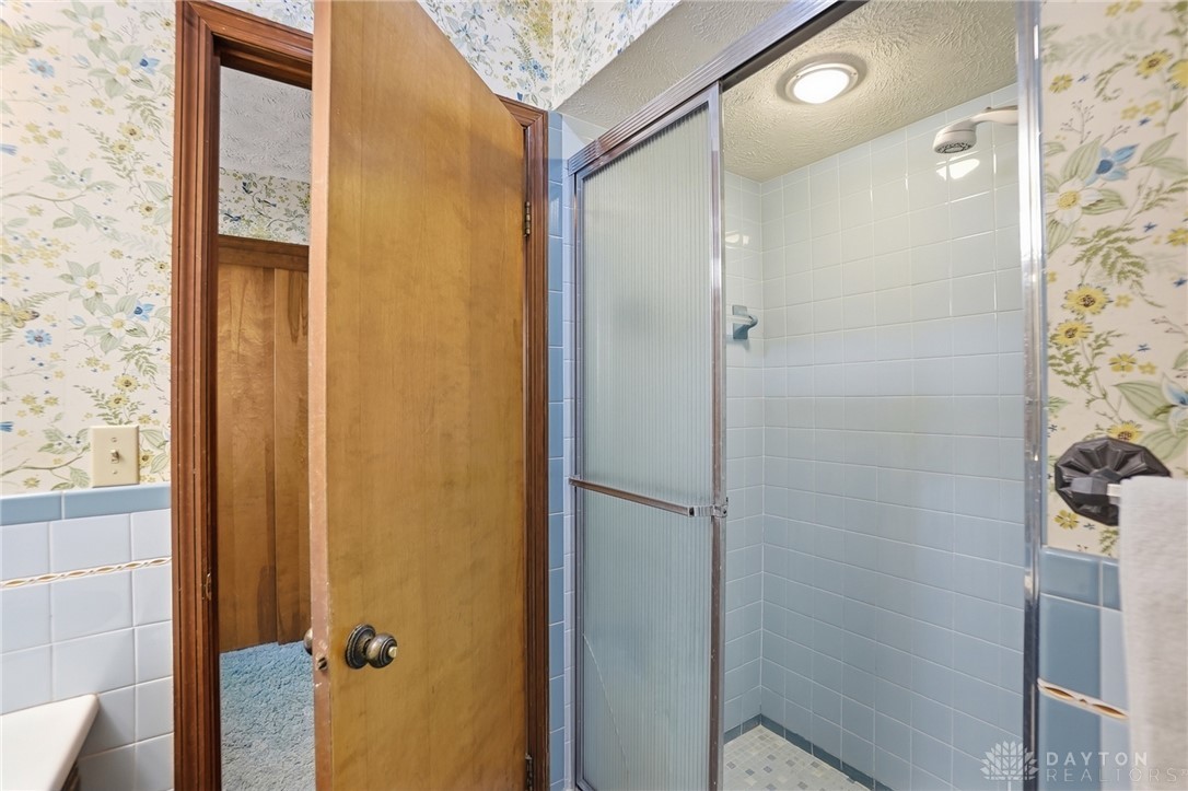 5669 O Neall Road Waynesville, OH 45068 - Photo 37 of 72 This bright bathroom features a functional shower with tiled walls and an inviting aesthetic.