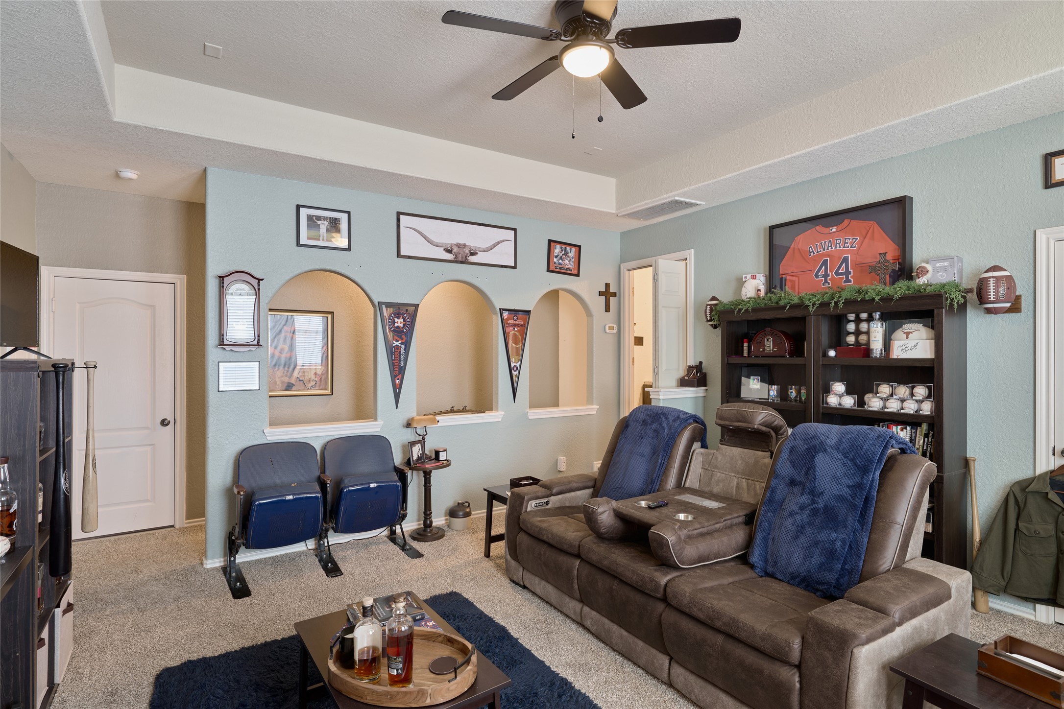 28322 Madelin Manor Lane Spring, TX 77386 - Photo 25 of 46 a living room with furniture a ceiling fan and a flat screen tv