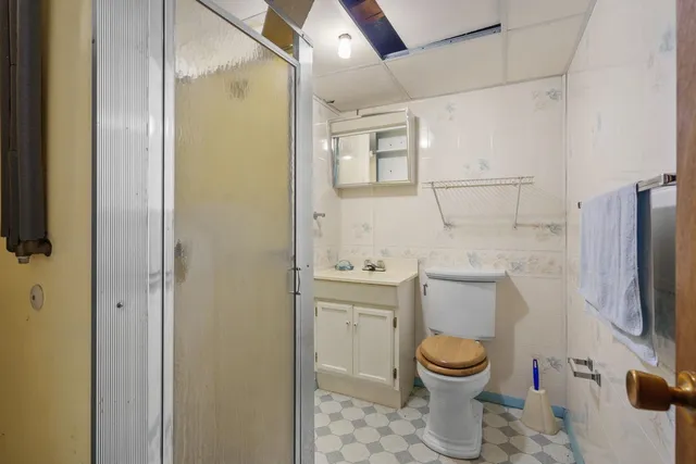 a bathroom with a toilet a sink and a shower