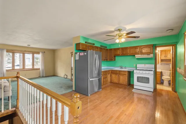 a kitchen with stainless steel appliances granite countertop a refrigerator and a stove top oven