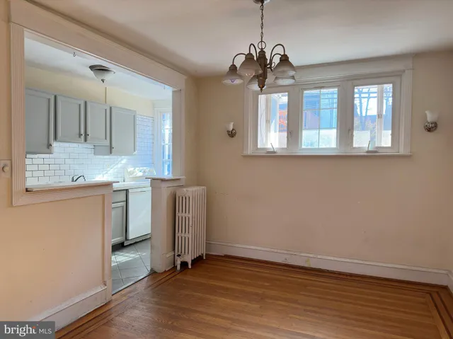 a view of a kitchen with a sink dishwasher and wooden floor